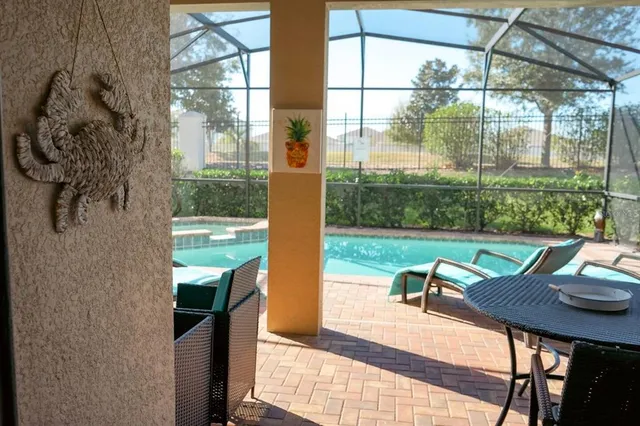 a view of a porch with furniture and garden
