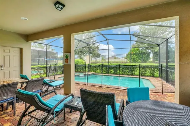 a view of a patio with a table chairs and a backyard