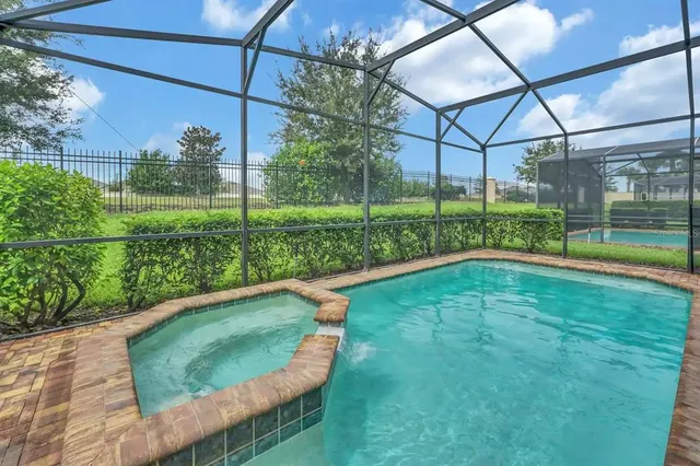 a view of a house with a backyard and a patio