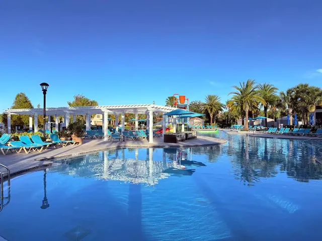 a view of a swimming pool with outdoor seating