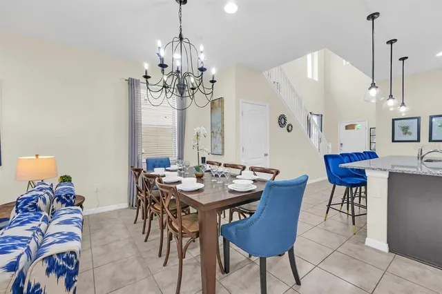 a view of a dining room with furniture and chandelier