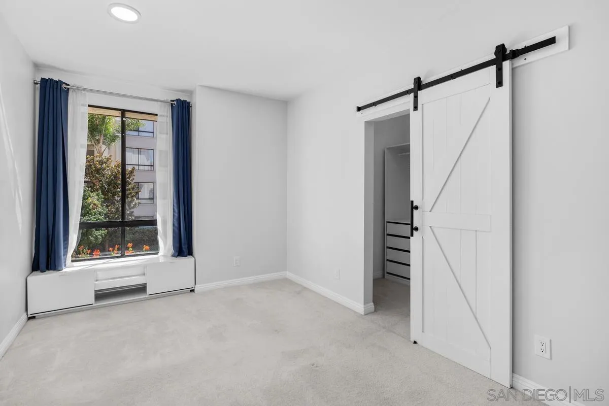 5845 Friars Road, Unit 1201 San Diego, CA 92110 - Photo 12 of 24 a view of an empty room with a window