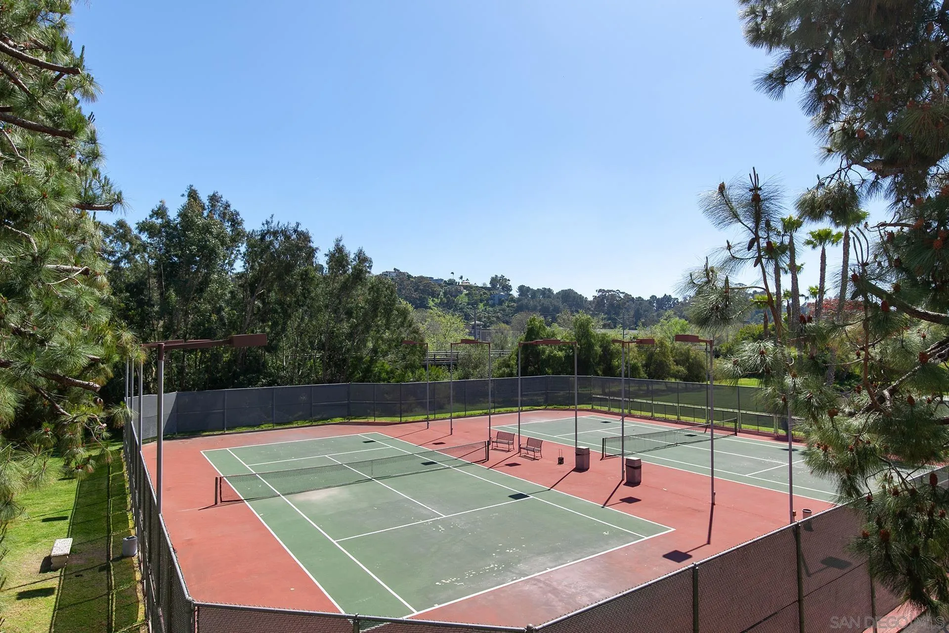 5845 Friars Road, Unit 1201 San Diego, CA 92110 - Photo 21 of 24 a view of a tennis ground with large trees