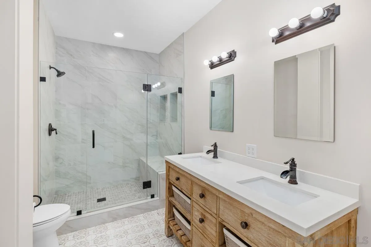 5845 Friars Road, Unit 1201 San Diego, CA 92110 - Photo 10 of 24 a bathroom with a sink double vanity and a shower