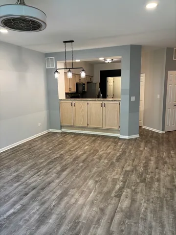 a view of a kitchen with a sink and a refrigerator