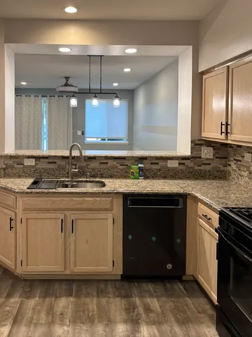 a kitchen with a sink stove and cabinets