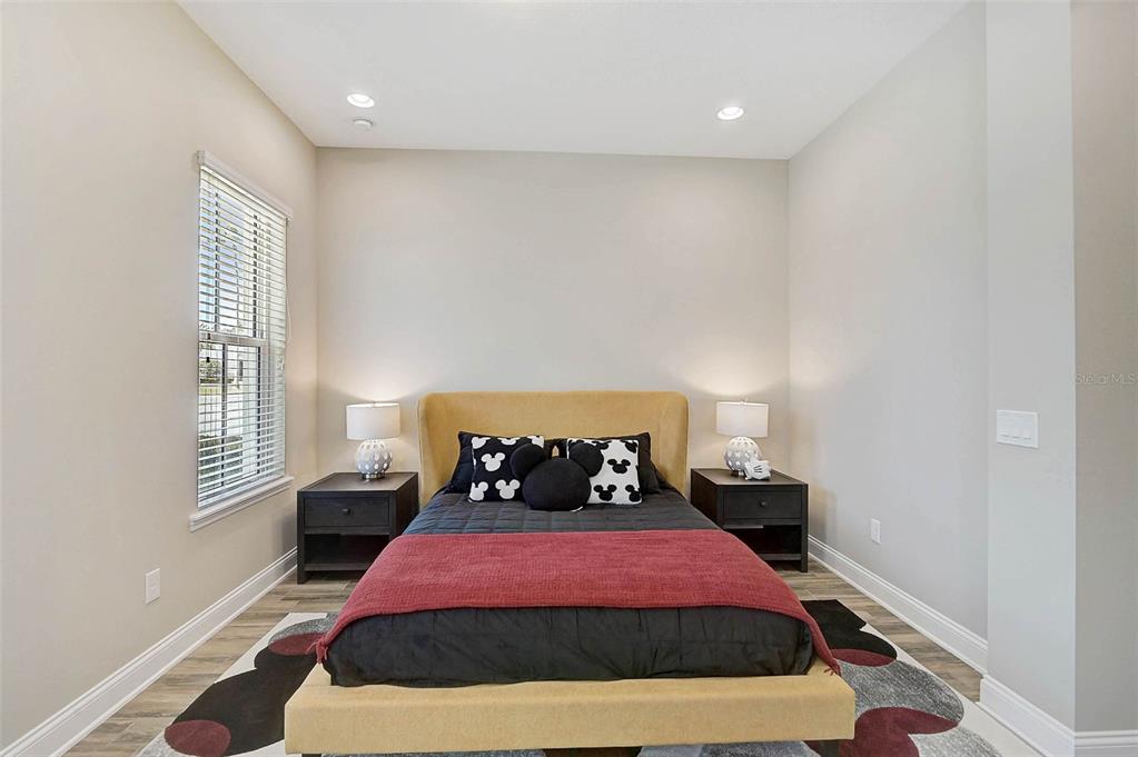 1616 Resolute Street Celebration, FL 34747 - Photo 29 of 46 a bedroom with a bed and wooden floor