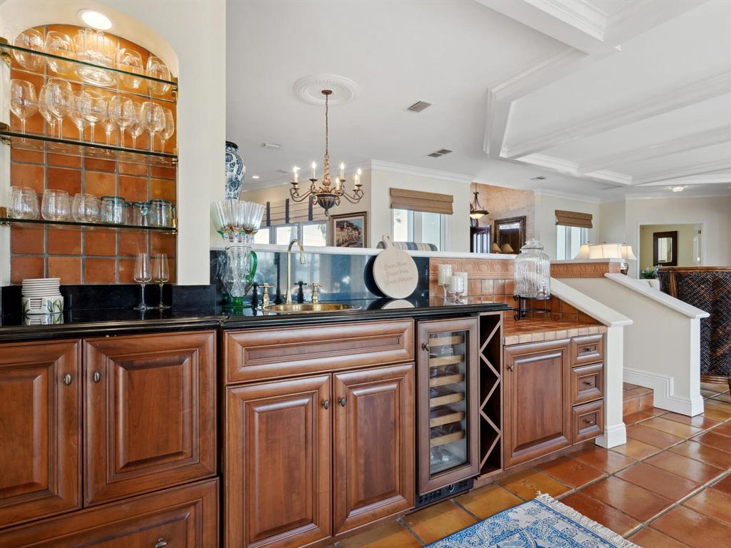 2110 Casey Key Road Nokomis, FL 34275 - Photo 13 of 75 a kitchen with kitchen island granite countertop a sink cabinets and stainless steel appliances