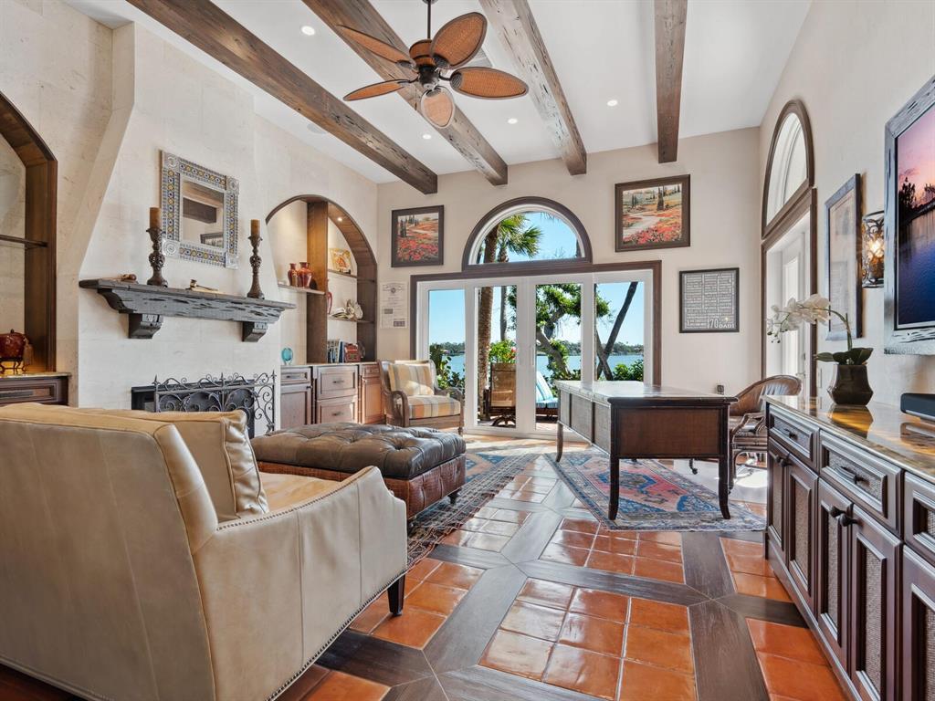 2110 Casey Key Road Nokomis, FL 34275 - Photo 14 of 75 a living room with furniture a fireplace and a large window