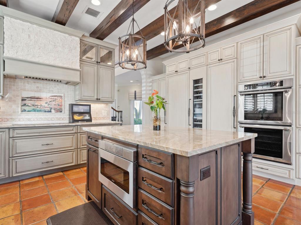 2110 Casey Key Road Nokomis, FL 34275 - Photo 18 of 75 a kitchen with a sink stainless steel appliances and chandelier
