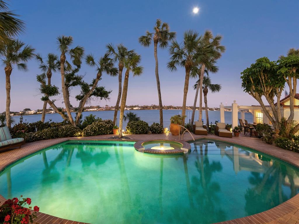 2110 Casey Key Road Nokomis, FL 34275 - Photo 2 of 75 a view of a swimming pool with a yard and palm trees