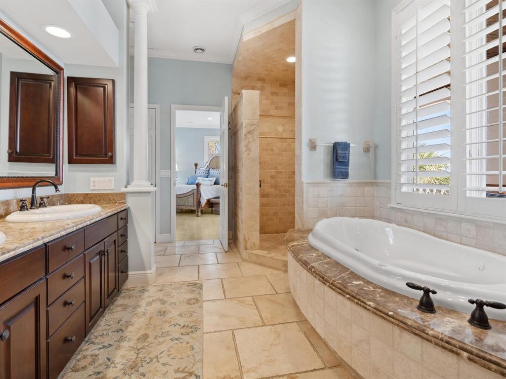 2110 Casey Key Road Nokomis, FL 34275 - Photo 30 of 75 a spacious bathroom with a tub sink and mirror