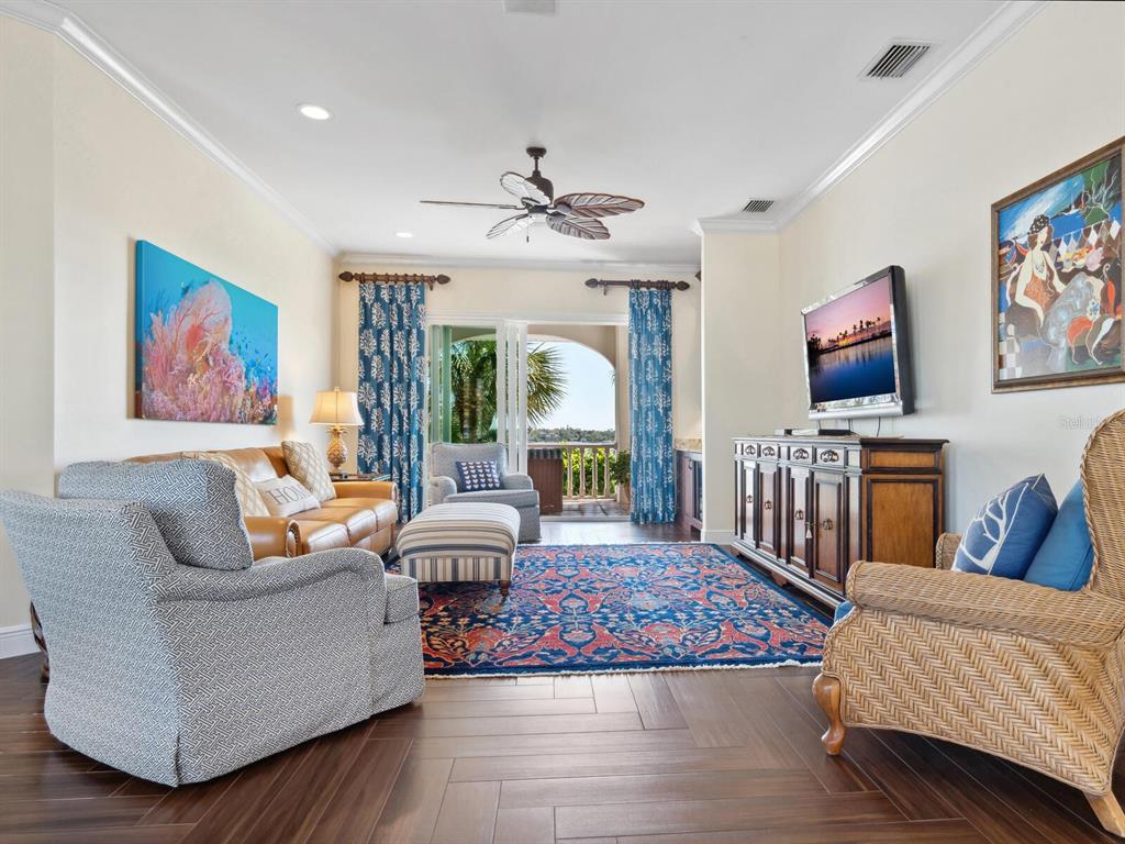 2110 Casey Key Road Nokomis, FL 34275 - Photo 31 of 75 a living room with furniture a rug and a chandelier