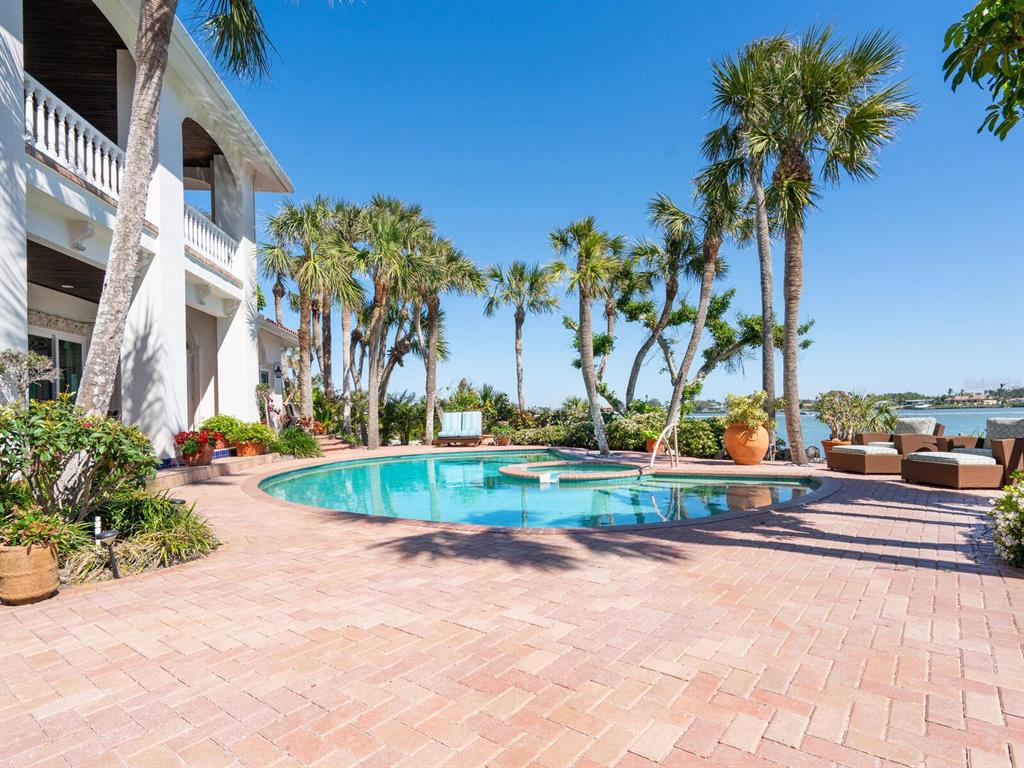 2110 Casey Key Road Nokomis, FL 34275 - Photo 43 of 75 a view of a swimming pool with a yard and palm trees
