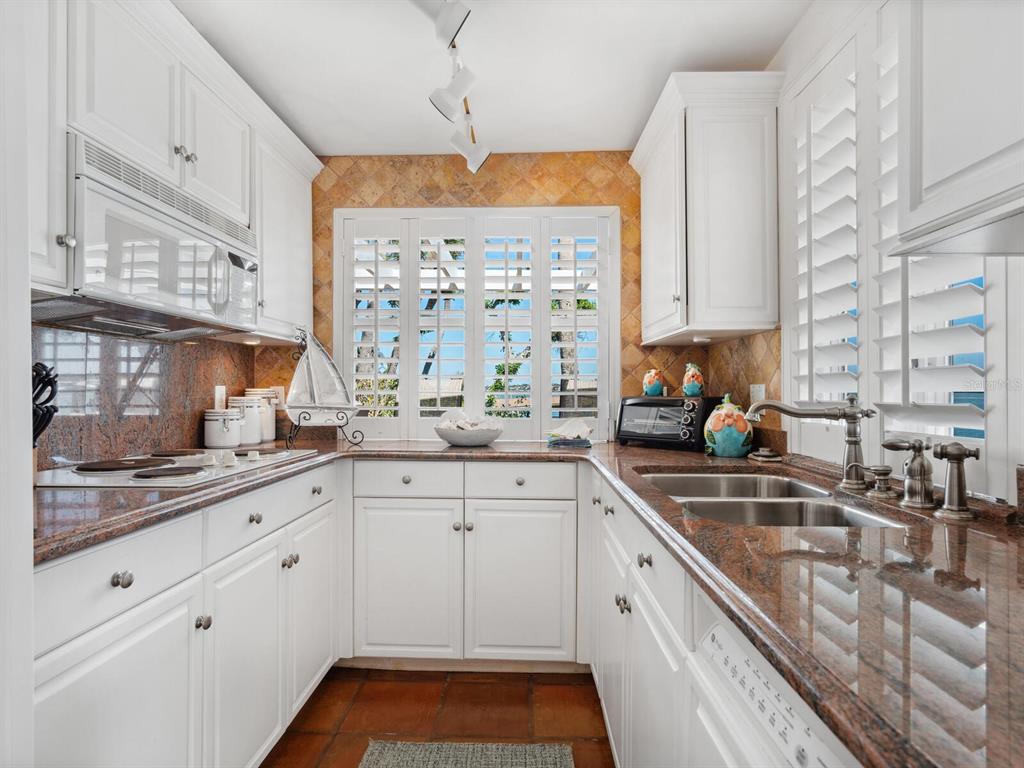 2110 Casey Key Road Nokomis, FL 34275 - Photo 46 of 75 a kitchen with a sink stove and cabinets