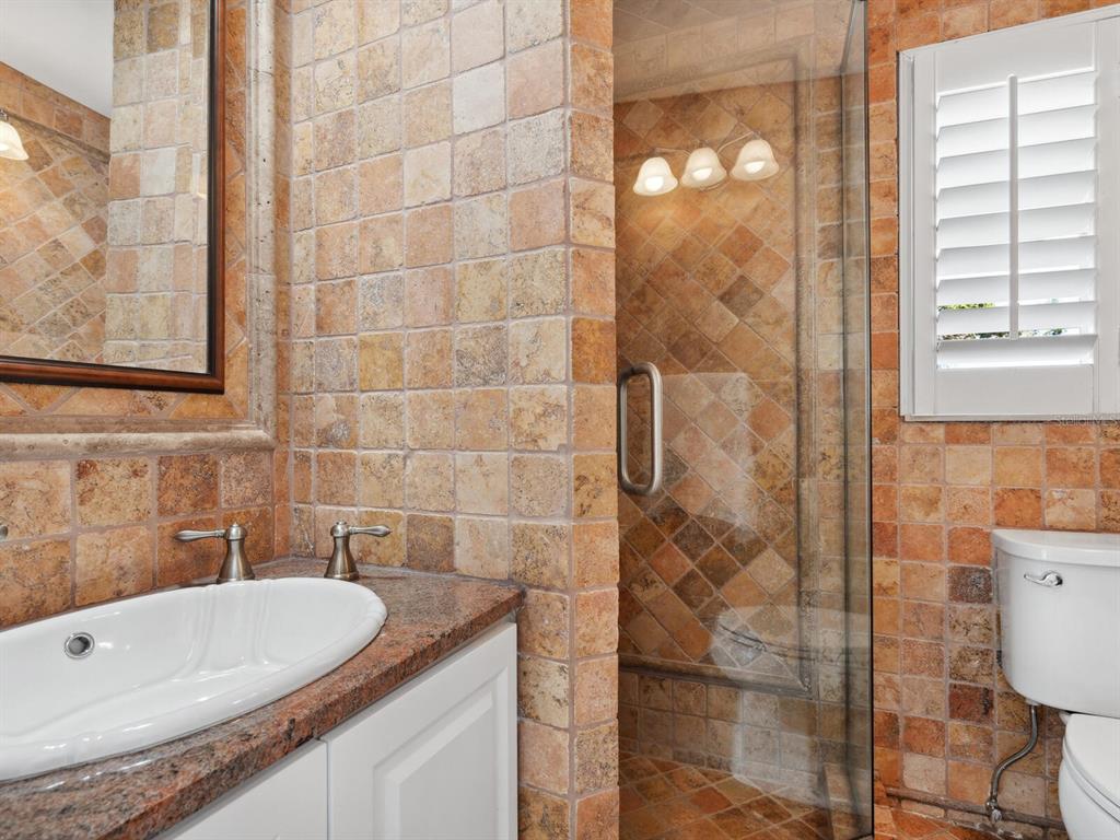 2110 Casey Key Road Nokomis, FL 34275 - Photo 49 of 75 a bathroom with a granite countertop bathtub and a shower