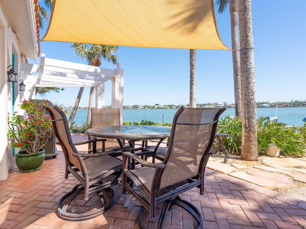2110 Casey Key Road Nokomis, FL 34275 - Photo 50 of 75 a view of a patio with table and chairs and potted plants
