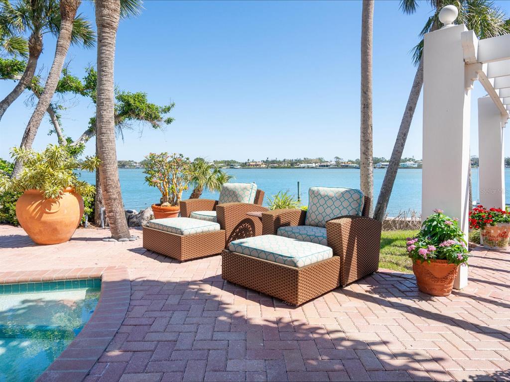 2110 Casey Key Road Nokomis, FL 34275 - Photo 57 of 75 a view of a patio with couches chairs and potted plants