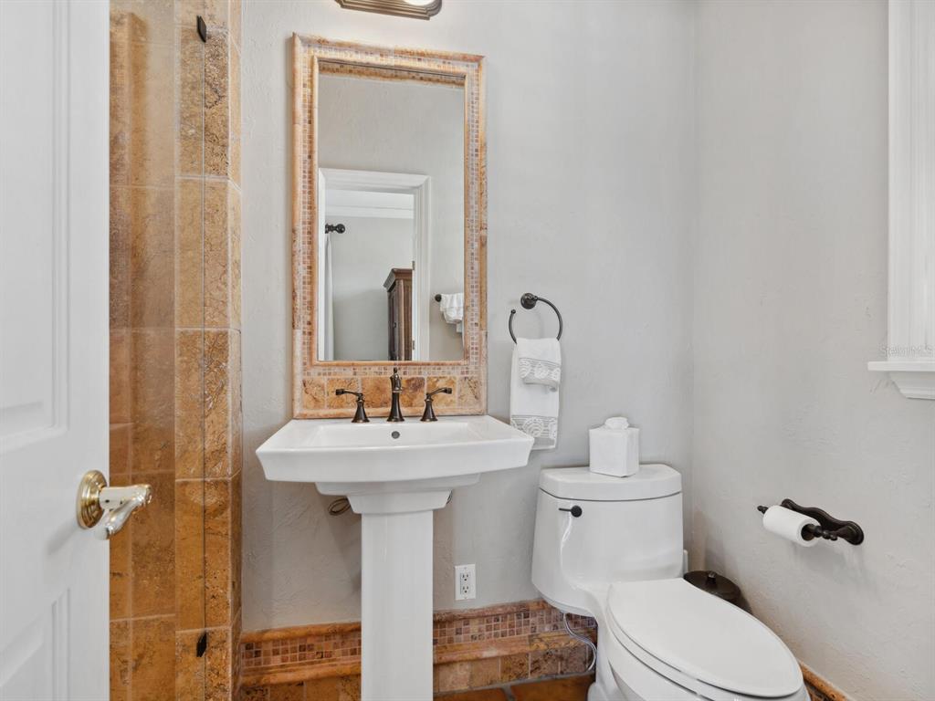 2110 Casey Key Road Nokomis, FL 34275 - Photo 67 of 75 a bathroom with a sink toilet and mirror