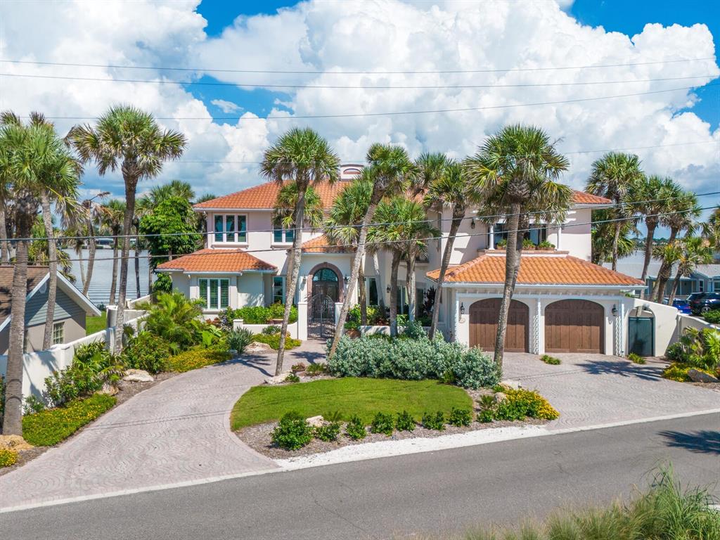 2110 Casey Key Road Nokomis, FL 34275 - Photo 68 of 75 a front view of a house with a yard and outdoor seating