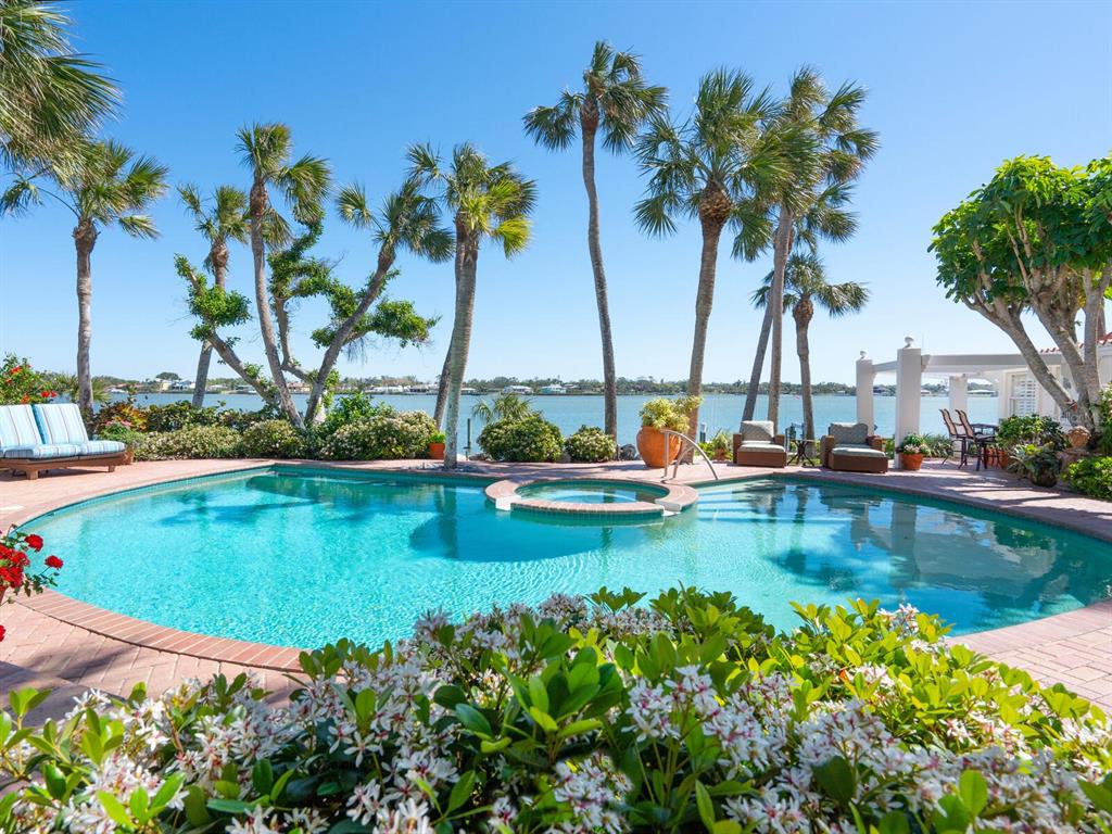 2110 Casey Key Road Nokomis, FL 34275 - Photo 10 of 75 a view of a swimming pool with a table and chairs