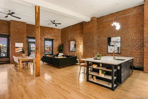 a living room with furniture a table and wooden floor