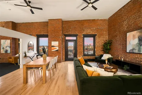 a living room with fireplace furniture and a wooden floor
