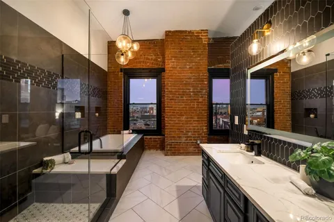 a bathroom with a granite countertop sink a toilet a mirror and bathtub
