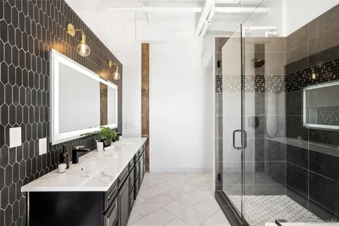 a bathroom with a double vanity sink and mirror
