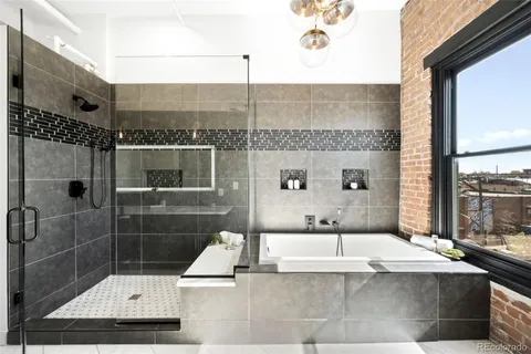 a bathroom with a bathtub and double sink