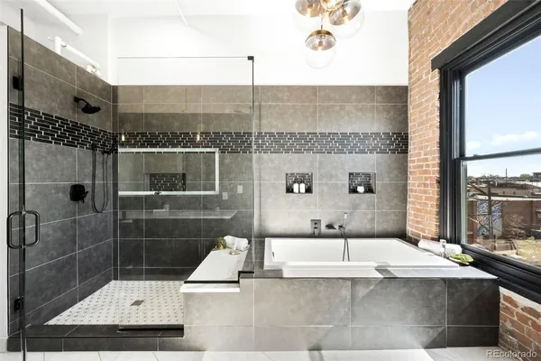 a bathroom with a bathtub and double sink
