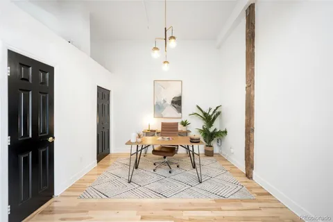 a work room with furniture and a potted plant