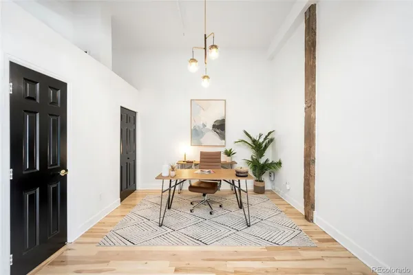 a work room with furniture and a potted plant