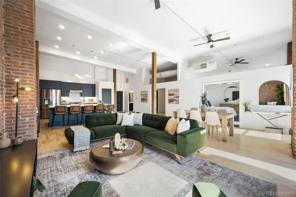 a living room with furniture and a view of kitchen
