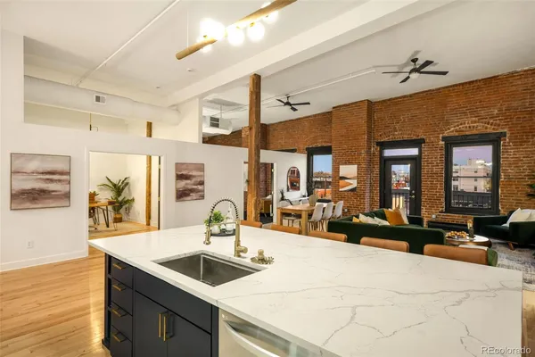 a kitchen with a sink appliances and a large window
