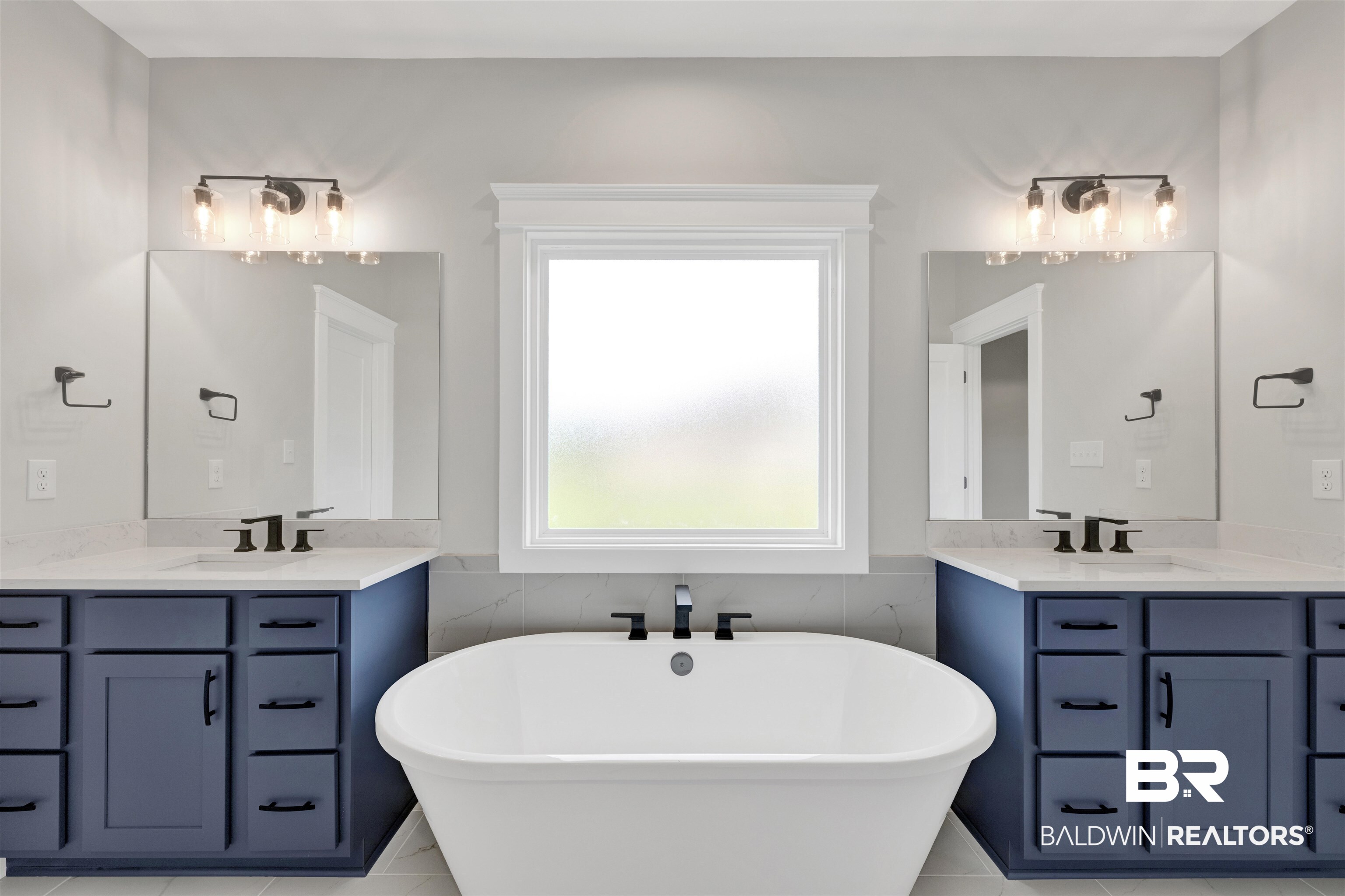 27315 Patch Pl Loop Daphne, AL 36526 - Photo 16 of 43 Full bath with two vanities, a soaking tub, and wainscoting
