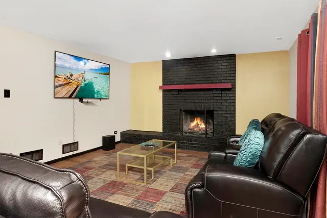 a living room with furniture and a fireplace