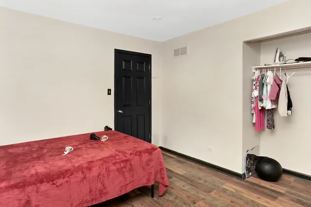 a bedroom with a bed and a desk