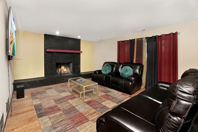a living room with furniture fireplace and rug