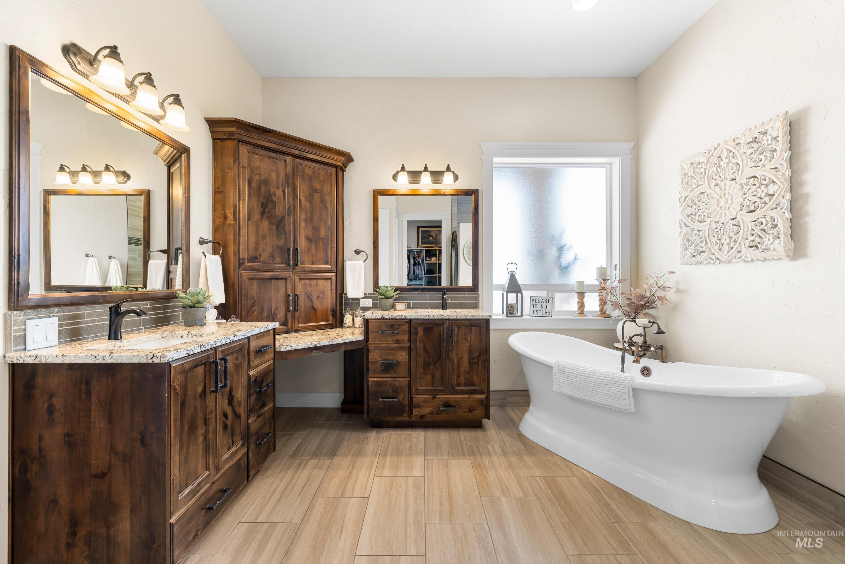 9819 Foothill Road Middleton, ID 83644 - Photo 26 of 49 Full bath with two vanities and a freestanding tub