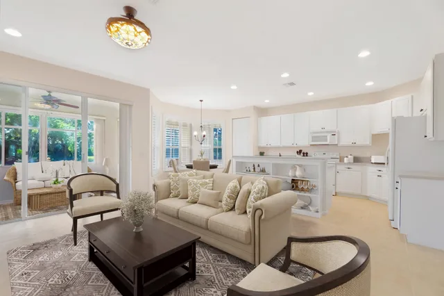 a living room with furniture a dining table and a stove with wooden floor