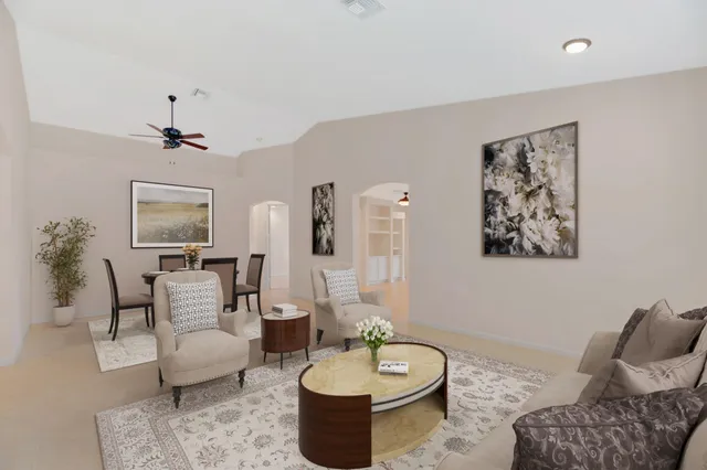 a living room with furniture and a potted plant