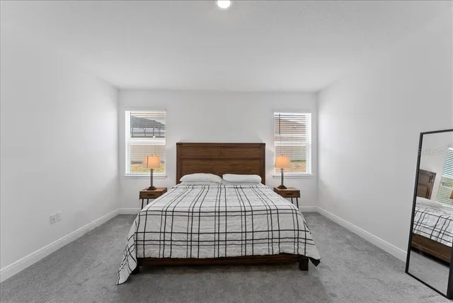 a bedroom with a bed and a tv on the dresser