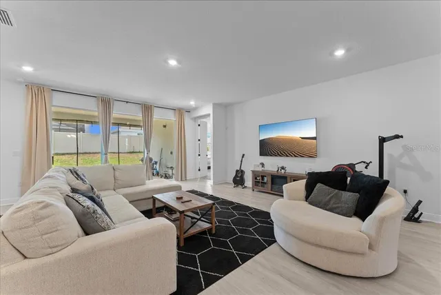 a living room with furniture and a lamp