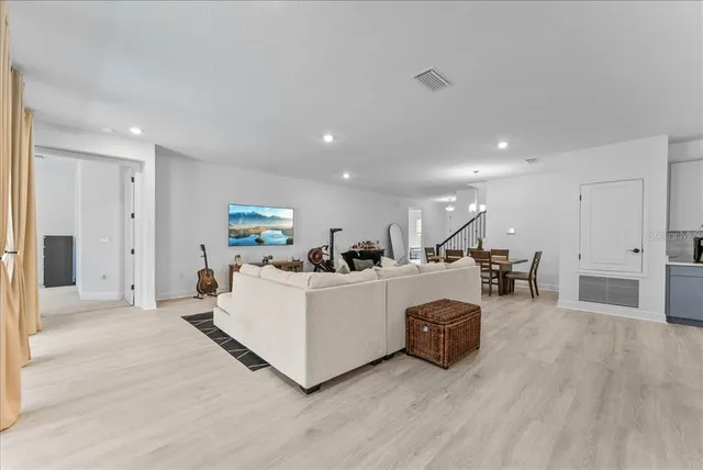 a living room with furniture a wooden floor and a fireplace