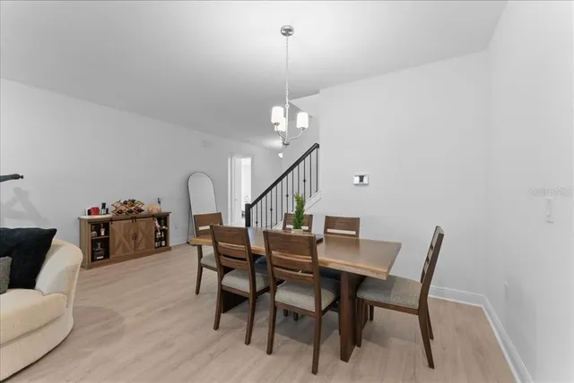 a dining room with furniture and wooden floor