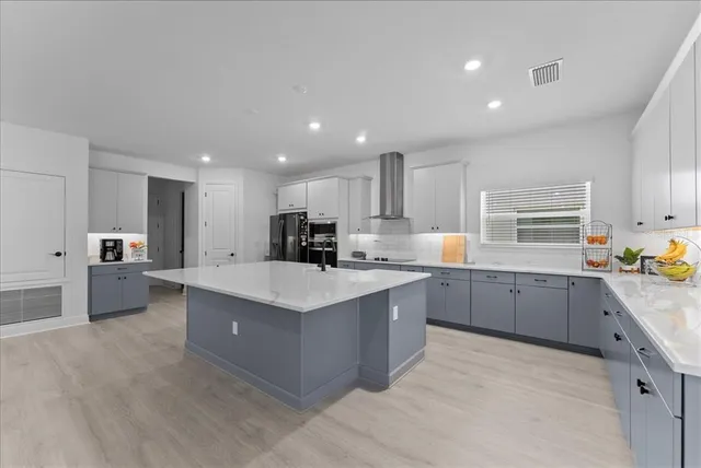 a large kitchen with stainless steel appliances lots of counter top space