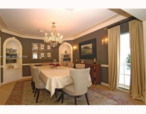 4511 Lake Road Miami, FL 33137 - Photo 11 of 14 a view of a dining room with furniture and a chandelier