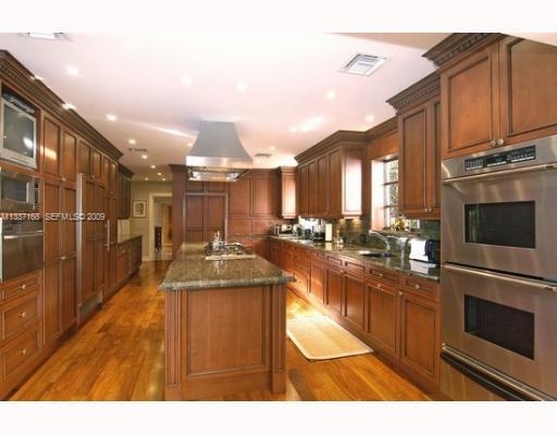 4511 Lake Road Miami, FL 33137 - Photo 12 of 14 a kitchen with stainless steel appliances granite countertop a sink and cabinets
