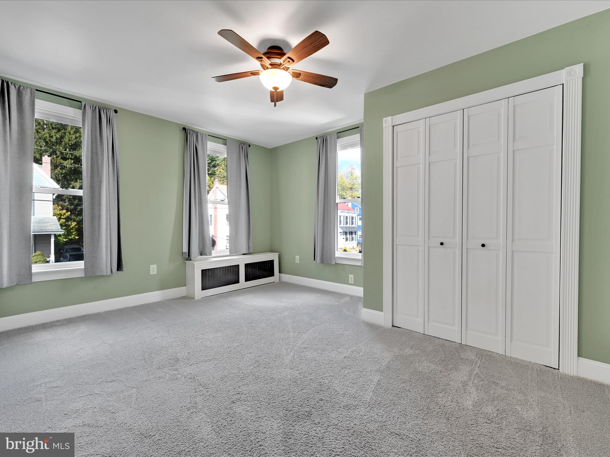 1425 Friedensburg Road Reading, PA 19606 - Photo 17 of 28 an empty room with chandelier fan and windows